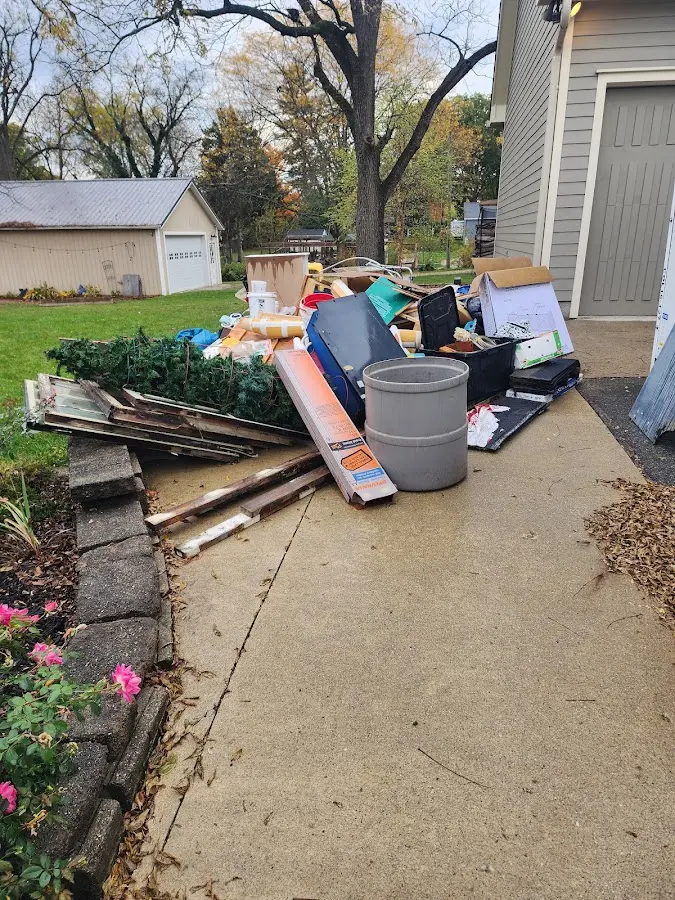 Dumpster being loaded with debris for Roofing Dumpster Rental in Paxton